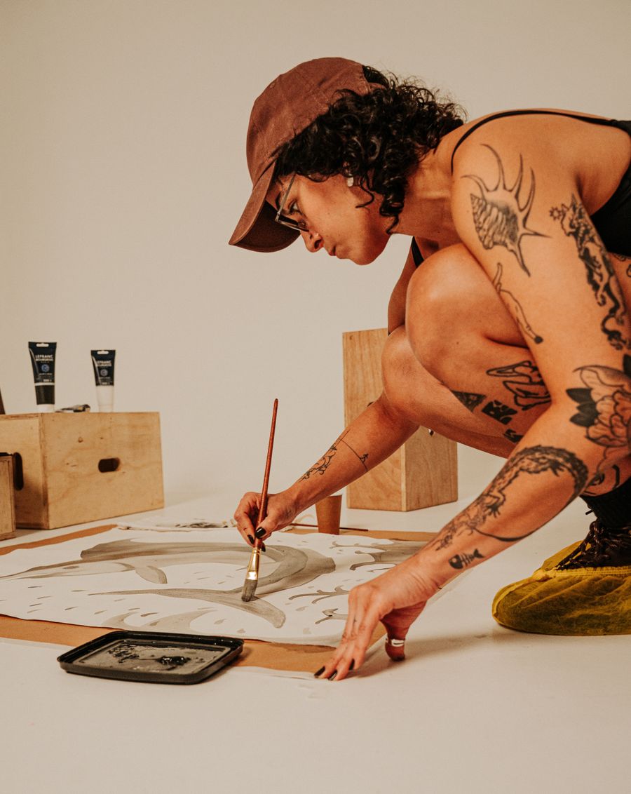 Artist painting an original artwork in a studio