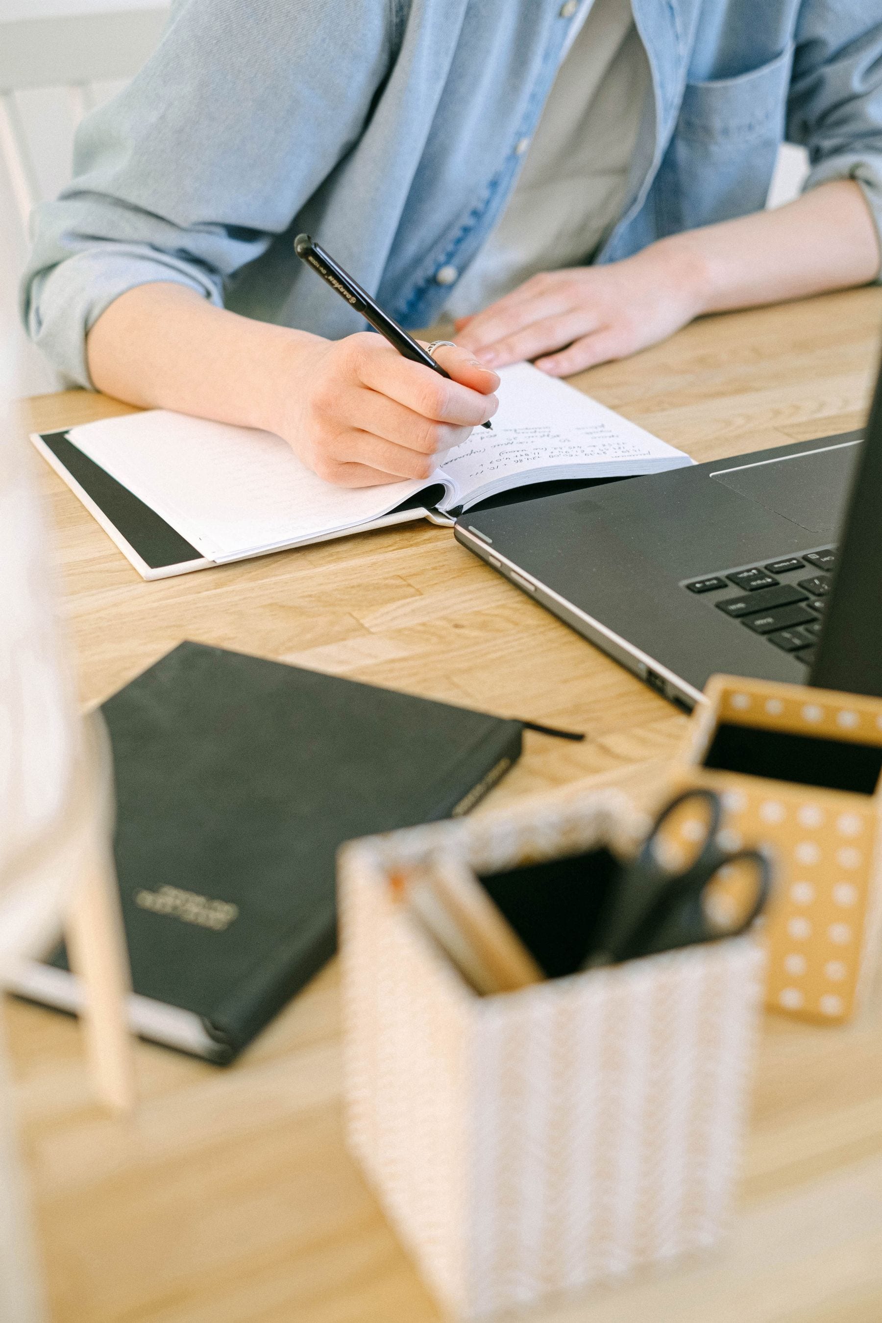 Blogger drafting an article beside a laptop and notebook