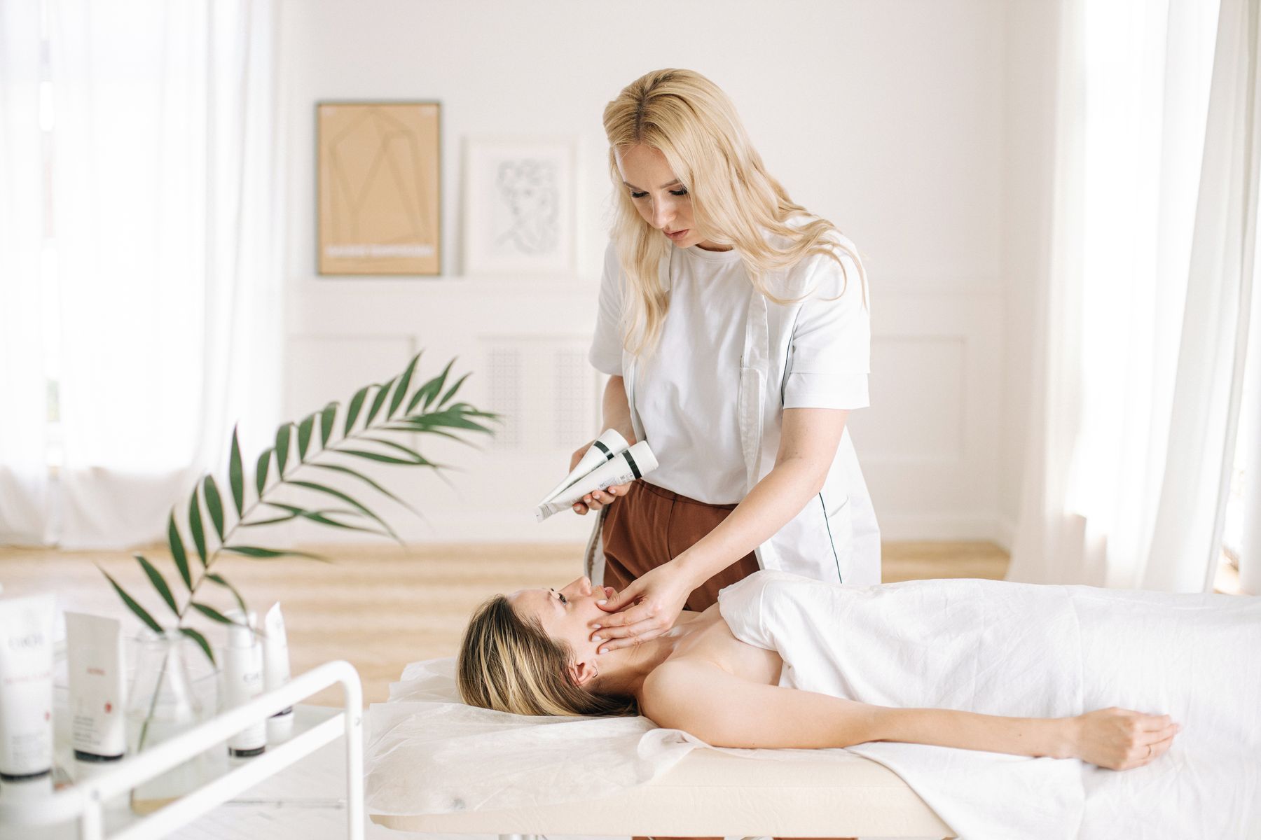 Esthetician examining a client before a skincare treatment