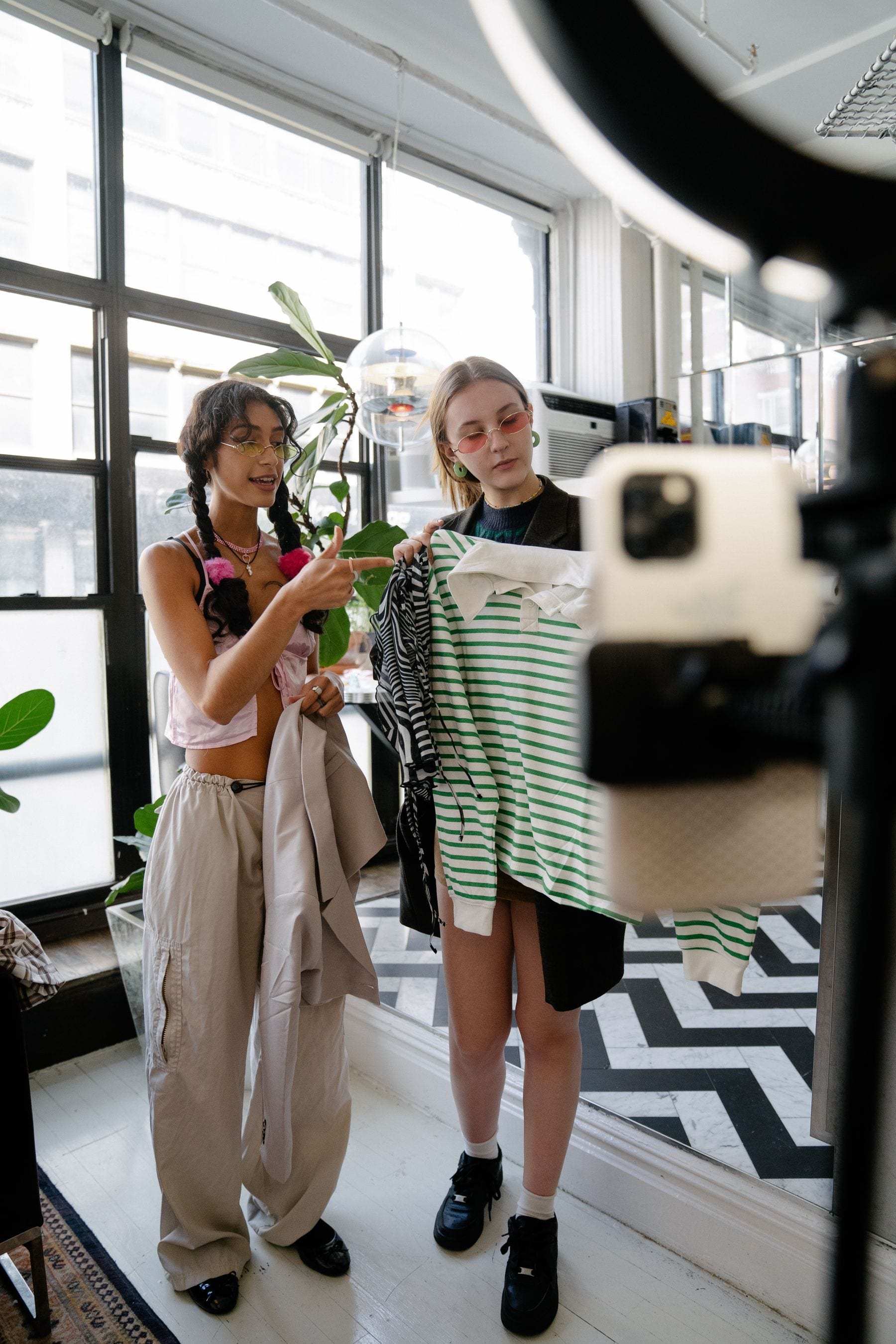 Fashion influencers recording outfit content for social media