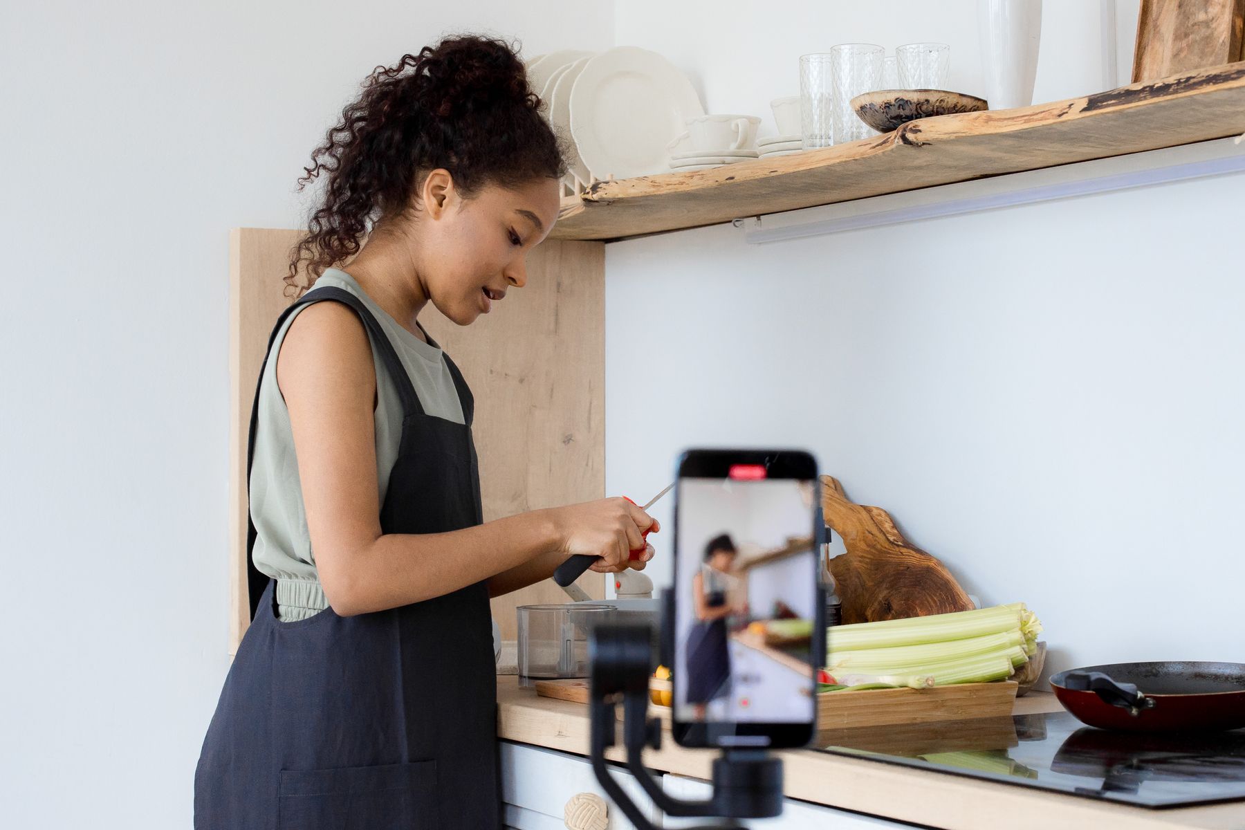 Food creator recording a cooking video in a home kitchen