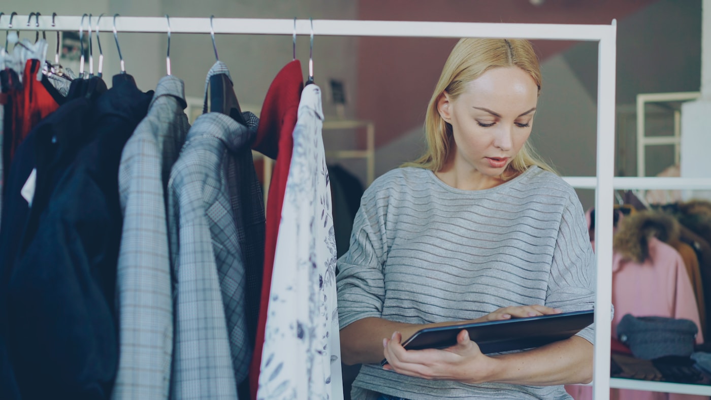 Woman reviews inventory in a clothing store