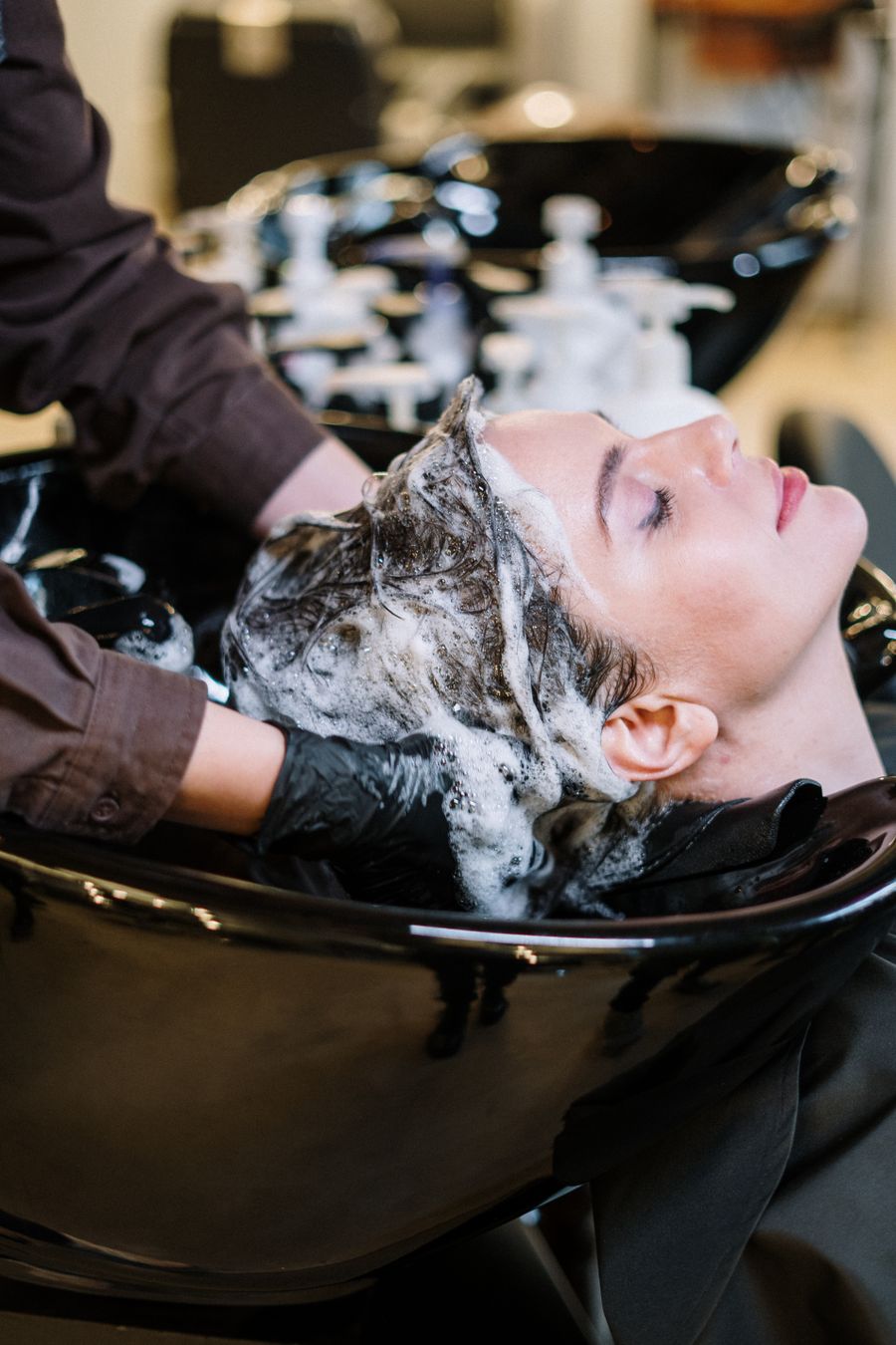 Hair stylist working with a salon client