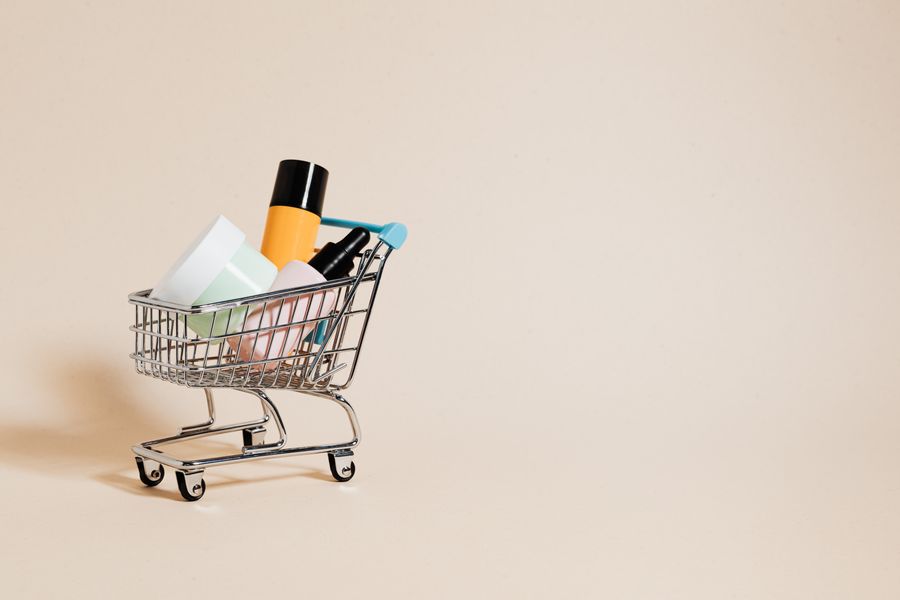 Retail beauty products arranged in a miniature shopping cart